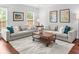 Bright living room with neutral decor, comfortable seating, and stylish coffee table at 100 Parkerwood Way, Alpharetta, GA 30022