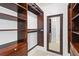 Walk-in closet with custom shelving, and a full length mirror for dressing at 100 Parkerwood Way, Alpharetta, GA 30022