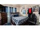 This bedroom has a patterned bed, a chair, and decor on the walls at 10044 Cormac St, Jonesboro, GA 30238