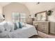 Bright bedroom with white linens, plenty of pillows, and a large dresser with mirror at 10044 Cormac St, Jonesboro, GA 30238