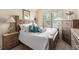 This bedroom features a charming bed with white linens and a decorative lamp on the nightstand at 10044 Cormac St, Jonesboro, GA 30238