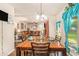 Inviting dining room featuring wood table, chandelier and lovely turquoise curtains at 10044 Cormac St, Jonesboro, GA 30238
