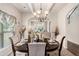 Elegant dining room with coffered ceiling, stylish chandelier, and a view into the cozy living space at 10044 Cormac St, Jonesboro, GA 30238