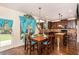 Cozy dining room adjacent to the kitchen, featuring a view to the yard through lovely turquoise curtains at 10044 Cormac St, Jonesboro, GA 30238