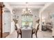 Cozy dining room featuring a traditional table setting, soft lighting, and a seamless flow to the living area at 10044 Cormac St, Jonesboro, GA 30238