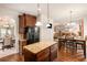 Spacious kitchen featuring a large island with granite countertops, stainless appliances and dark cabinetry at 10044 Cormac St, Jonesboro, GA 30238