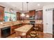 Well-lit kitchen featuring granite countertops, stainless appliances, island, and beautiful dark wood cabinets at 10044 Cormac St, Jonesboro, GA 30238