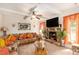 Warm living room boasting a stone fireplace, plush sectional sofa, and a cozy, inviting ambiance at 10044 Cormac St, Jonesboro, GA 30238