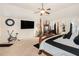 Large primary bedroom with vaulted ceiling, sitting area, and decorative wall art at 10044 Cormac St, Jonesboro, GA 30238