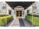 Elegant building entrance with gold trim, ornate lighting, and manicured landscaping at 3201 Lenox Ne Rd # 23, Atlanta, GA 30324