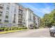 Attractive condo building with balconies, manicured shrubs, and parking area at 3201 Lenox Ne Rd # 23, Atlanta, GA 30324