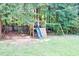 Large backyard with mature trees and a playground at 40 Queensland Ln, Covington, GA 30016