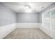 Comfortable bedroom with ceiling fan, bright window, and wainscoting at 40 Queensland Ln, Covington, GA 30016