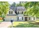 Charming two-story home featuring an attached two-car garage, lush landscaping, and inviting front porch at 40 Queensland Ln, Covington, GA 30016