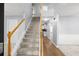 Inviting foyer featuring a staircase with wood and white railings and neutral paint colors at 40 Queensland Ln, Covington, GA 30016