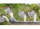 An aerial view of a suburban homes with well-manicured lawns and a playground in a fenced backyard at 4395 Capstone Court, Roswell, GA 30075