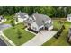 Aerial shot reveals a spacious home with lush landscaping, ample driveway space, and a well-kept lawn at 4395 Capstone Court, Roswell, GA 30075