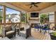 Relaxing outdoor space with a fireplace, TV, and comfortable seating area at 4395 Capstone Court, Roswell, GA 30075