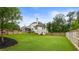 Lush backyard with mature trees, a covered patio, and a fenced perimeter, providing a private outdoor retreat at 4395 Capstone Court, Roswell, GA 30075