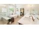 Well-lit bathroom with a soaking tub, glass-enclosed shower, and double vanity at 4395 Capstone Court, Roswell, GA 30075
