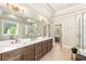 Modern bathroom featuring a soaking tub, glass-enclosed shower, and double vanity at 4395 Capstone Court, Roswell, GA 30075