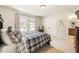 Bedroom with a plaid bedspread and a view of the backyard at 4395 Capstone Court, Roswell, GA 30075