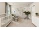 Bright Bedroom featuring a white crib, rocking chair, and calming decor at 4395 Capstone Court, Roswell, GA 30075