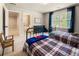 Bedroom with two metal beds, a large window, and access to the bathroom at 4395 Capstone Court, Roswell, GA 30075