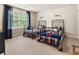 Bedroom with two metal beds, a large window, and plaid bedding at 4395 Capstone Court, Roswell, GA 30075