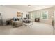 Spacious bonus room with neutral carpet, large sectional, and lots of natural light from the windows at 4395 Capstone Court, Roswell, GA 30075