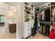 Spacious walk-in closet with custom shelving, storage, and access to ensuite bathroom at 4395 Capstone Court, Roswell, GA 30075
