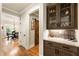 View of butler's pantry with wine storage, sliding barn door and access to the dining area at 4395 Capstone Court, Roswell, GA 30075