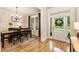 Dining room with hardwood floors, wainscoting, chandelier, and large window to the front yard at 4395 Capstone Court, Roswell, GA 30075