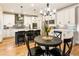 Well-appointed kitchen with white cabinets, stainless appliances, island with seating, and a breakfast area at 4395 Capstone Court, Roswell, GA 30075