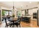 Eat-in kitchen with stainless steel appliances, modern cabinetry, and a view to the outdoor screened-in patio at 4395 Capstone Court, Roswell, GA 30075