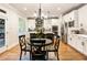Charming kitchen features white cabinets, stainless steel appliances, and a breakfast table at 4395 Capstone Court, Roswell, GA 30075