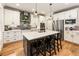 This kitchen offers white cabinets, stainless steel appliances, and an island with seating at 4395 Capstone Court, Roswell, GA 30075