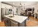 The kitchen features an island, stainless steel appliances, and opens to a living room with a fireplace at 4395 Capstone Court, Roswell, GA 30075