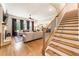 Bright living room features hardwood floors, large windows, and a cozy fireplace at 4395 Capstone Court, Roswell, GA 30075