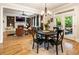 Open floor plan: living room flows to dining, featuring hardwood floors, and cozy furniture at 4395 Capstone Court, Roswell, GA 30075