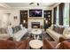 Spacious living room with a brick fireplace, built-in shelving, and comfortable seating arrangement at 4395 Capstone Court, Roswell, GA 30075