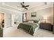 Bright main bedroom with tray ceilings, neutral tones, and an ensuite bathroom at 4395 Capstone Court, Roswell, GA 30075
