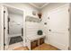 Bright mudroom boasts coat rack with bench and built-in storage. Laundry room is adjacent at 4395 Capstone Court, Roswell, GA 30075