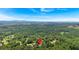 An aerial view of a house with a red pin against a background of trees and distant mountains at 17 Sassafras Ne Trl, Cartersville, GA 30121