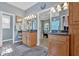 Bathroom with dual sinks, granite counters, wooden cabinets, and an entrance to the main bedroom at 17 Sassafras Ne Trl, Cartersville, GA 30121