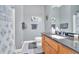 The bathroom is equipped with wood cabinets, a granite countertop, and blue and grey accents at 17 Sassafras Ne Trl, Cartersville, GA 30121