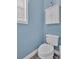 Powder room featuring a white toilet, a white cabinet, and blue walls at 17 Sassafras Ne Trl, Cartersville, GA 30121