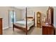 The bedroom boasts a four-poster bed, neutral walls, and lots of natural light from the window at 17 Sassafras Ne Trl, Cartersville, GA 30121
