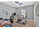 This well-lit room features a ceiling fan, two exercise machines, and natural light from the window at 17 Sassafras Ne Trl, Cartersville, GA 30121
