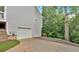 Side view of house featuring garage, steps, and trees at 17 Sassafras Ne Trl, Cartersville, GA 30121